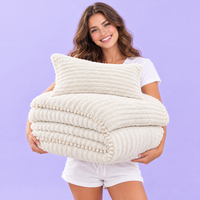 Woman holding the folded Cloudline comforter set